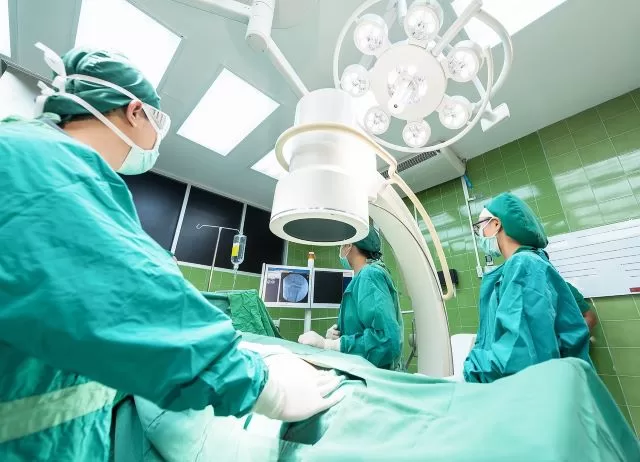 Operating room with surgeons and C-arm for orthopedic surgery